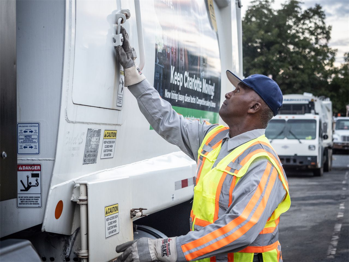A SWS worker by a city truck