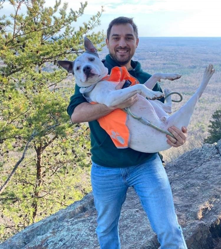 supervisor cody with his dog on a mountain