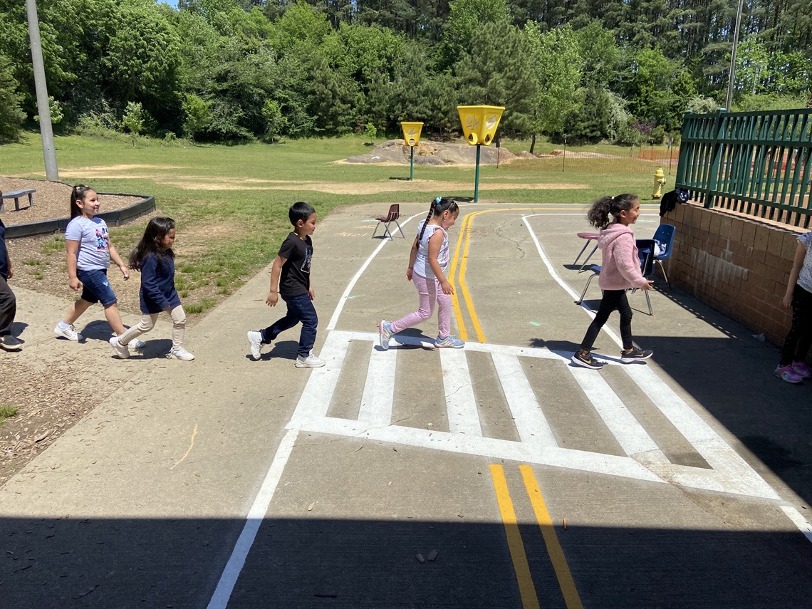 Kids in a traffic garden crosswalk