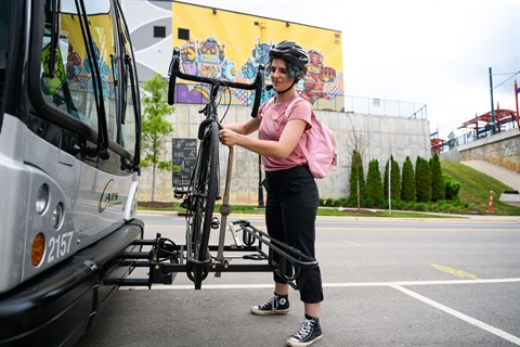 CATS rider putting their bike on the bus bike rack