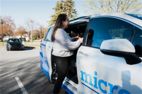 person entering vehicle marked 'micro' on door