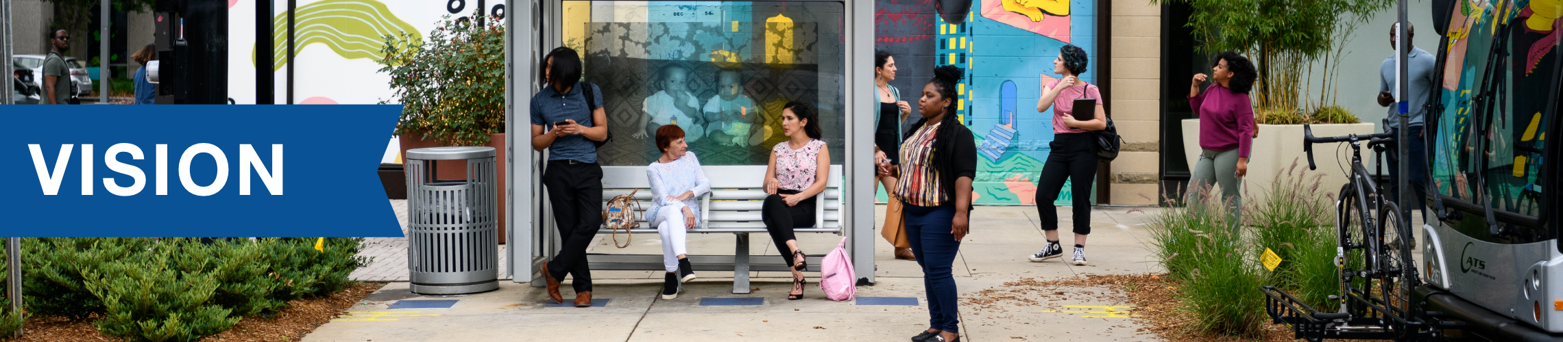CATS Riders sitting and standing around rail platform, waiting for the transit vehicle