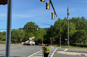 Implementation staff inspecting new traffic signal installation