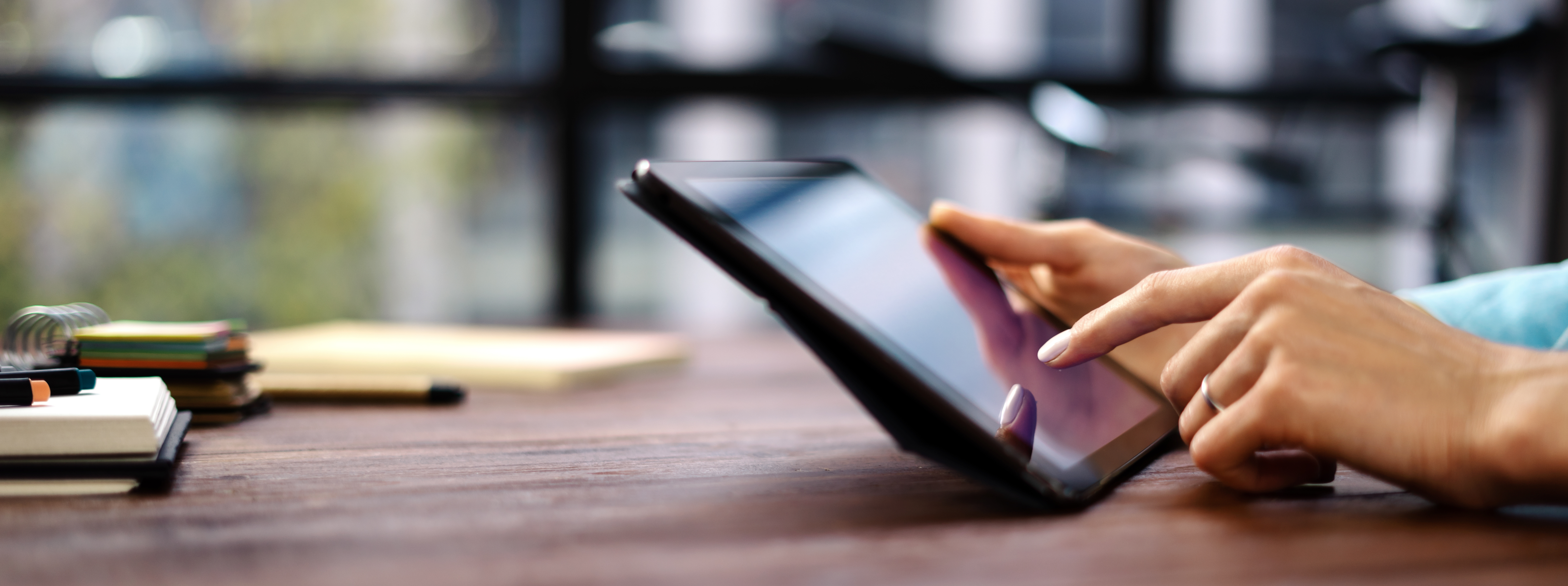 Close-up of person's hands interacting with tablet