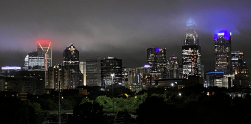 night time image of the city of charlotte with towers lights on