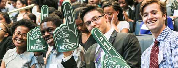 MYEP Students smiling at the camera while holding #1 hand props at the MYEP Kickoff event.