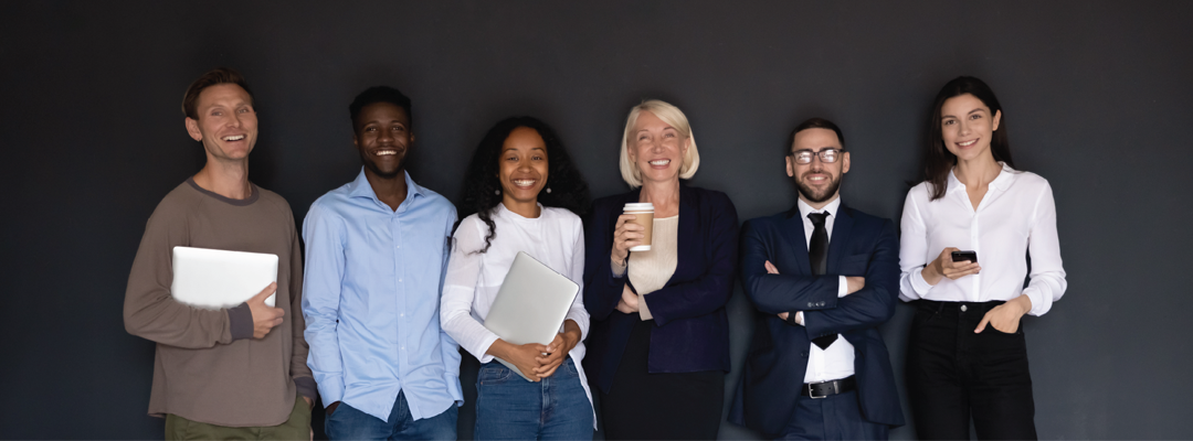 Six people wearing business casual clothes, holding different items including laptops, a coffee cup, and a phone