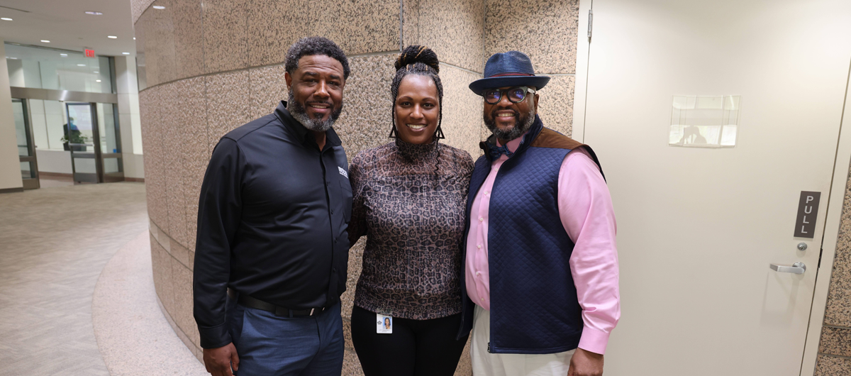 Business owner standing next to two city employees