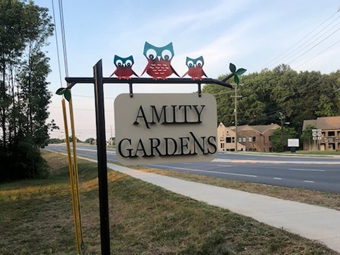 image of a sign that reads Amity Gardens
