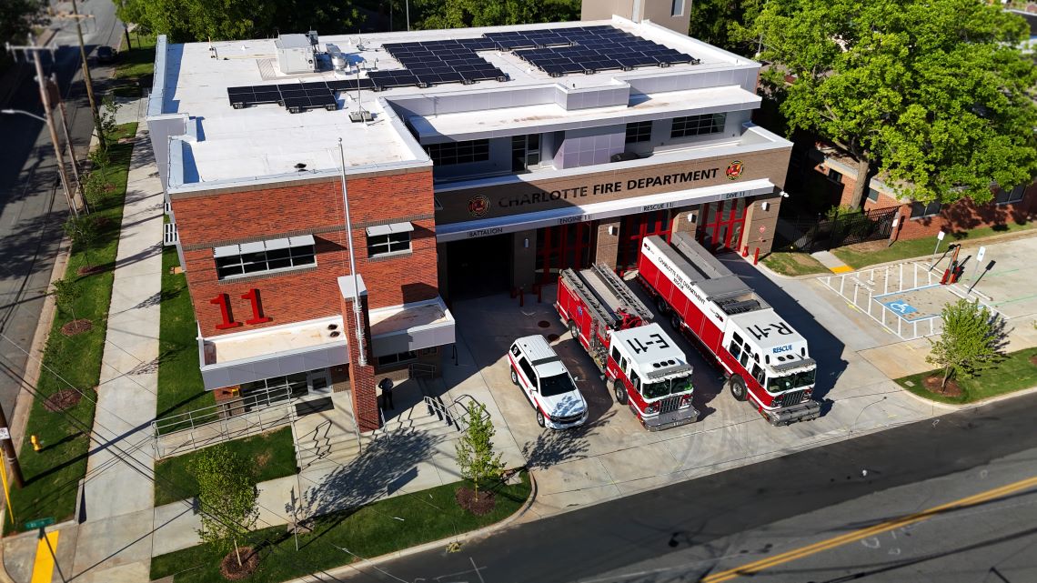 aerial photo of a new firehouse with two firetrucks parked i front