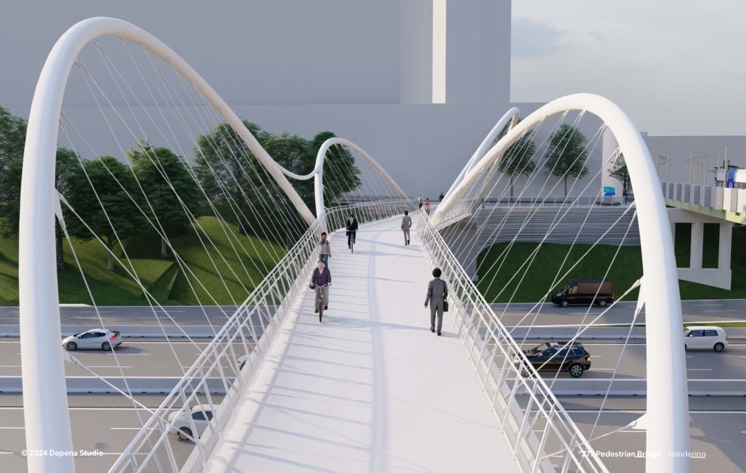 view of bridge from bridge deck, with tall undulating spans on either side and pedestrians traveling over it