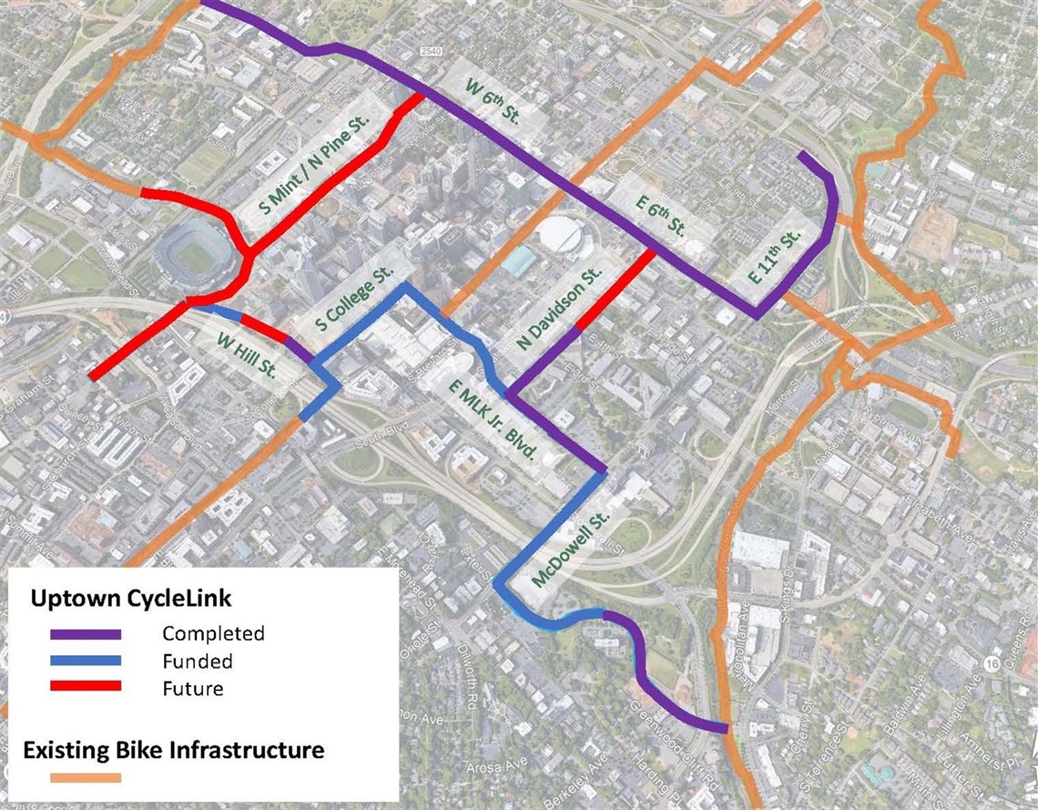 a map of uptown overlaid with different colored lines representing completed, funded and future bike lane segments