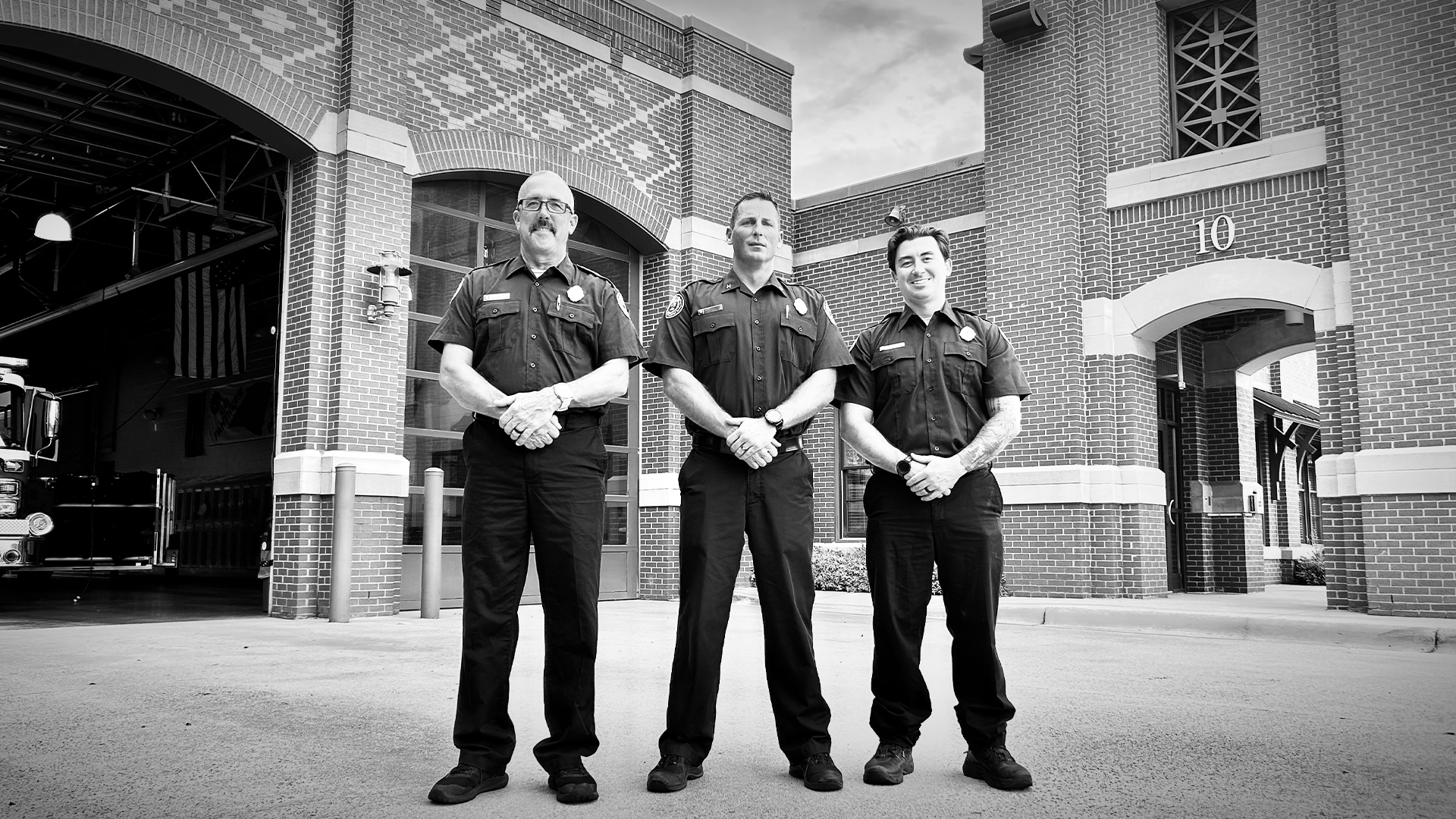 Captain John Booth, Engineer Kevin Stines, and Firefighter II Austen King stand outside Firehouse 10, where their teamwork is at the heart of their mission.