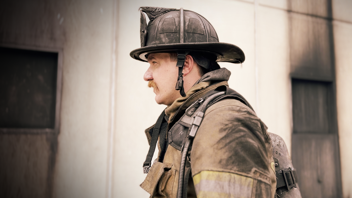 Captain Alex Gordon, fully geared, prepares for another hands-on training session, ensuring recruits are ready for the demands of the job.