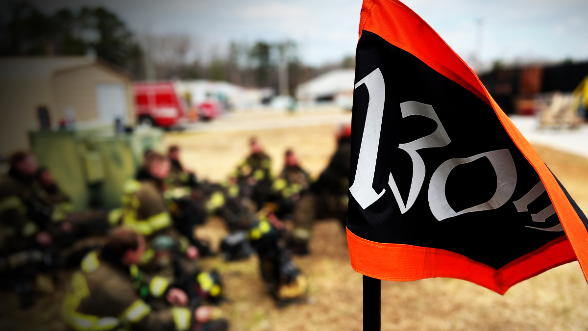 The Recruit Class 130 flag waves as recruits gather, marking the culmination of months of dedication and hard work.