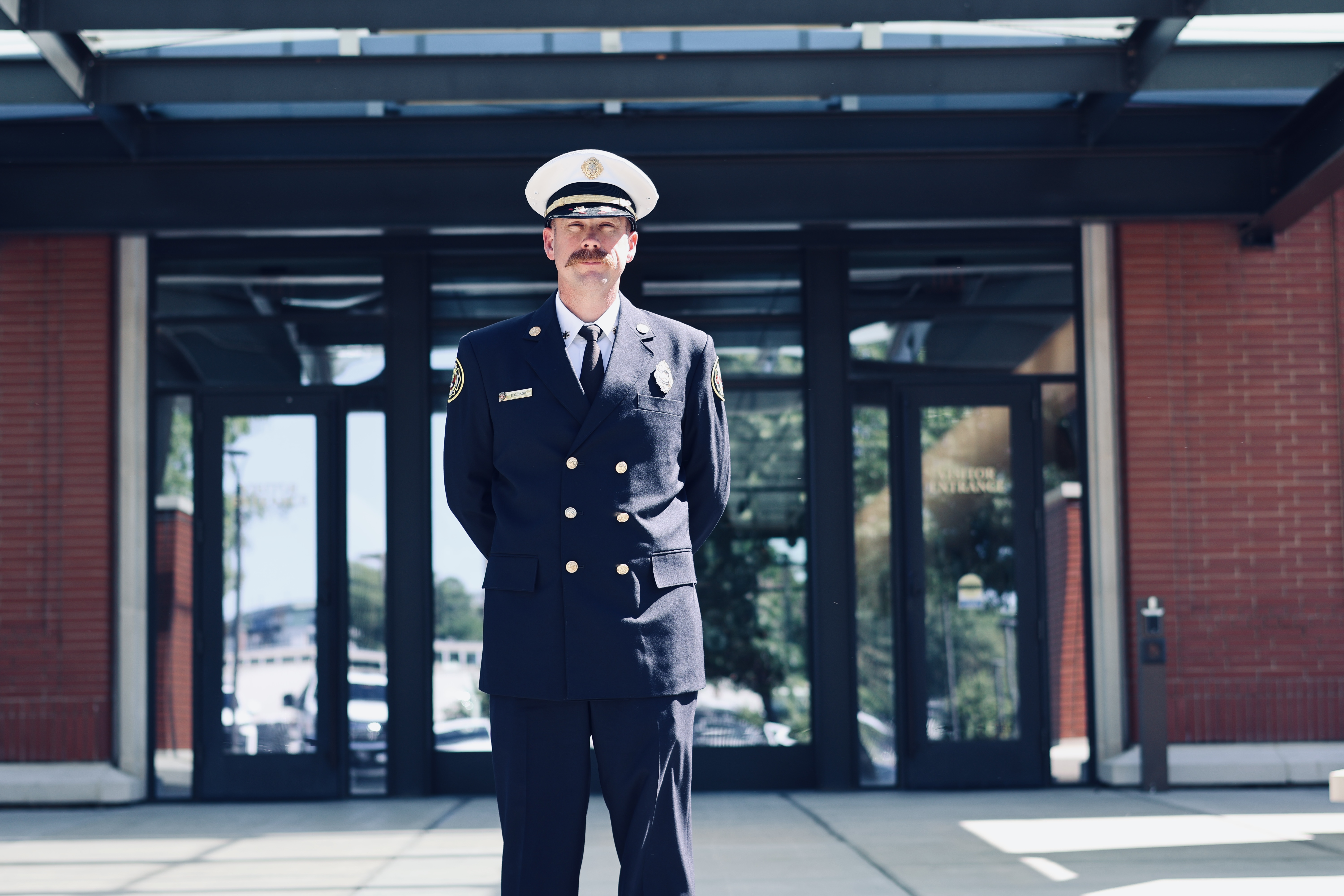 Bobby Cash stands outside Charlotte Fire Headquarters, where he is being promoted from battalion chief to division chief.