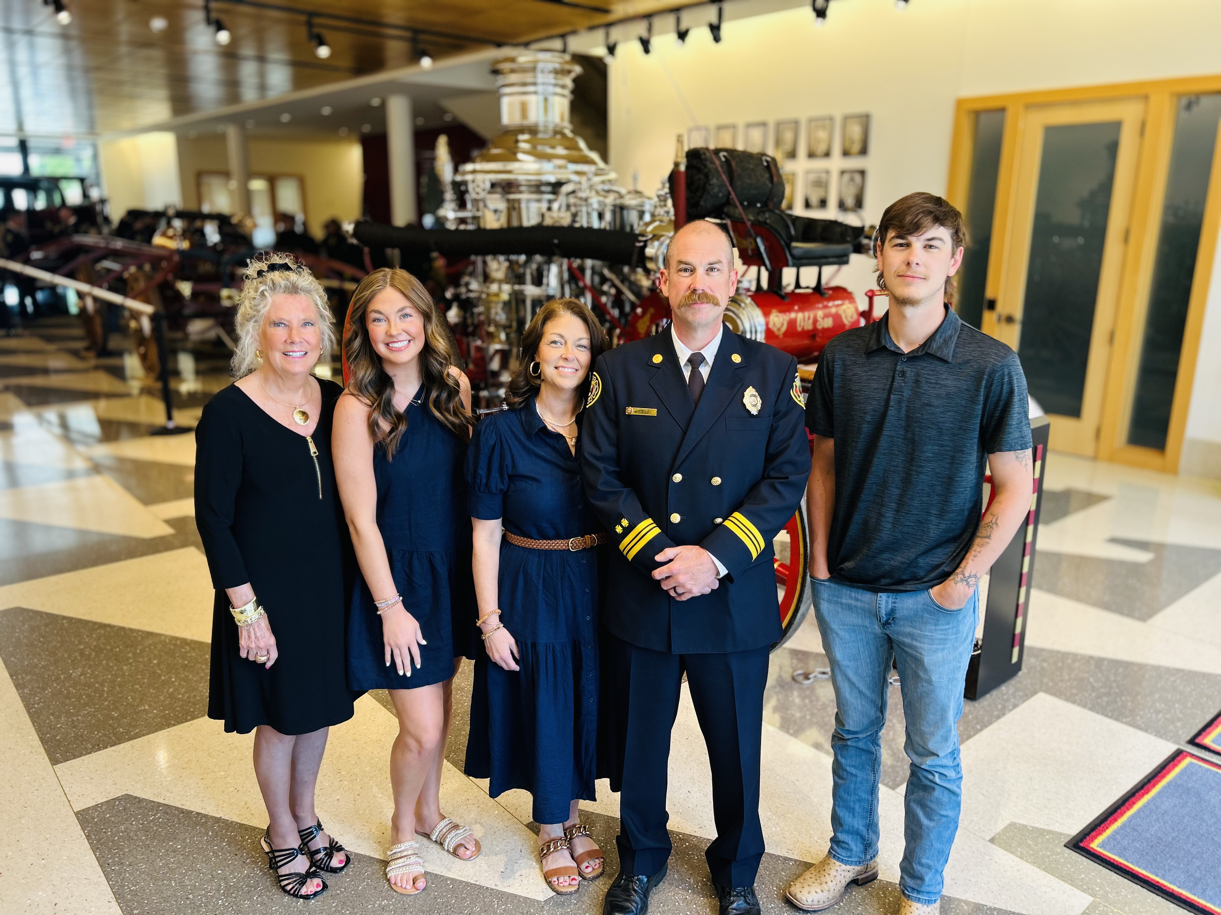 Bobby Cash stands with his family, including his mother Sheila, following his promotion ceremony. The moment reflected not only a professional milestone, but the family support behind his service with Charlotte Fire.