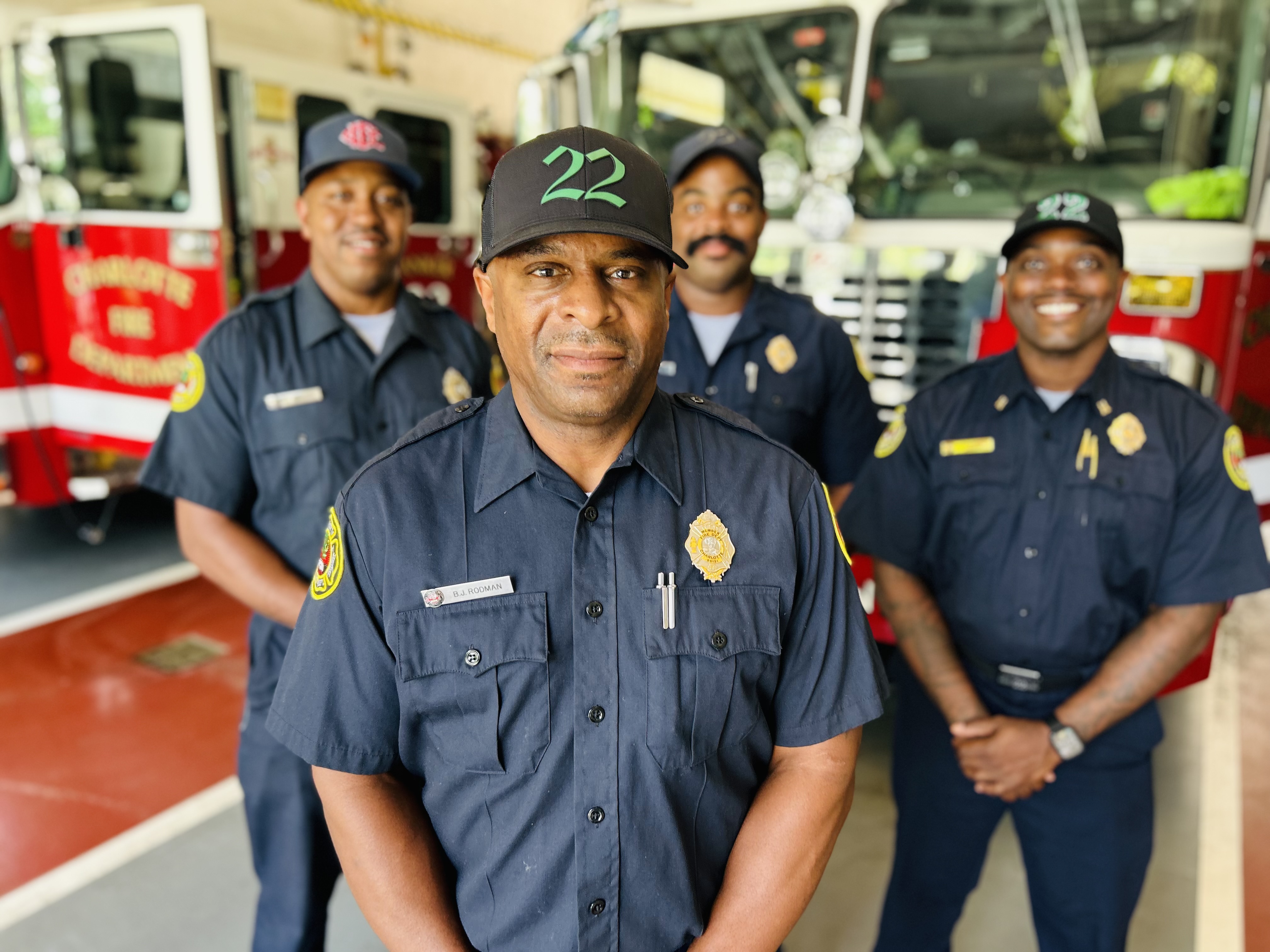 Rodman in sharp focus as his Engine 22 crew stands behind him, a reminder of the support system that kept him steady during his battle with cancer.
