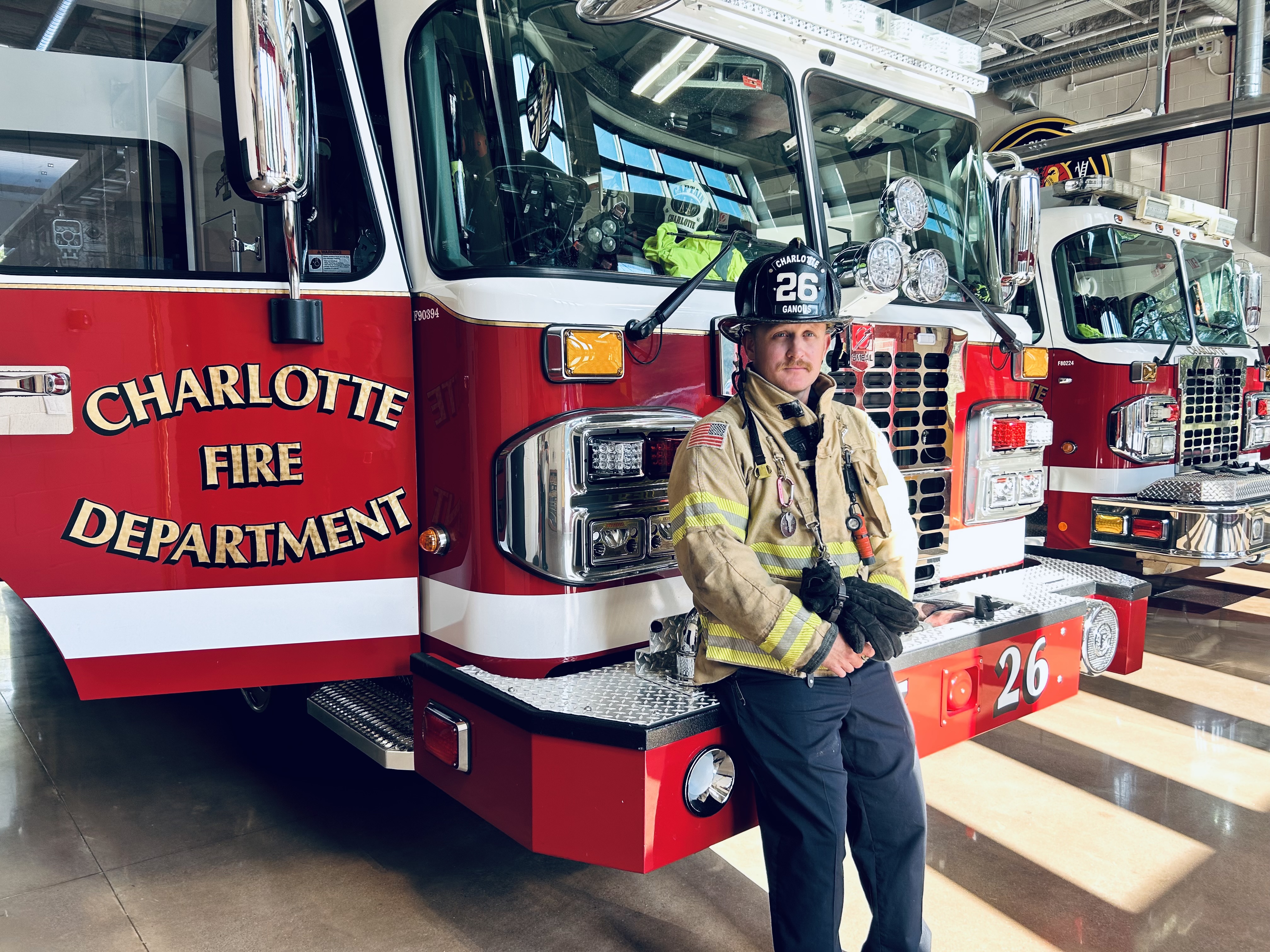 Ganous stands with Engine 26 after helping provide stem cells for a patient battling blood cancer.