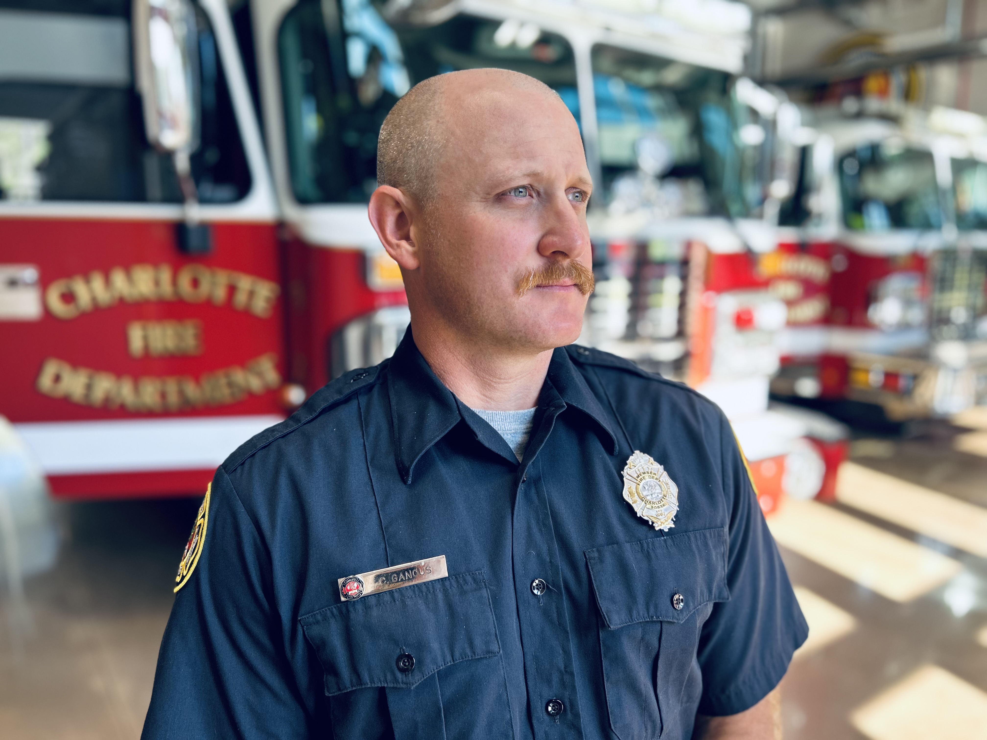 Ganous stands beside Engine 26 after being selected as a stem cell donor for a patient battling blood cancer.