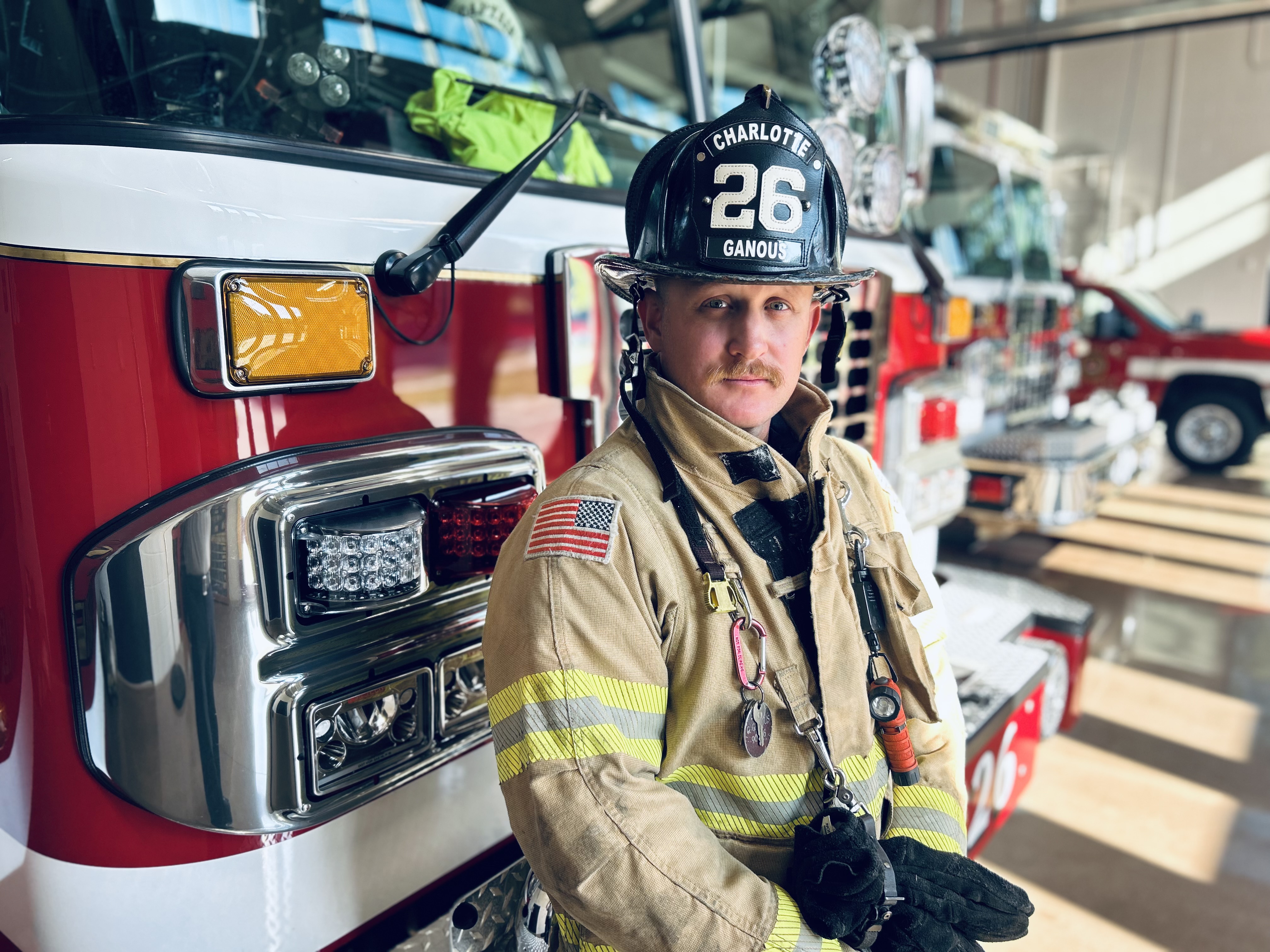 Ganous gears up beside Engine 26 while serving neighborhoods across the Queen City.