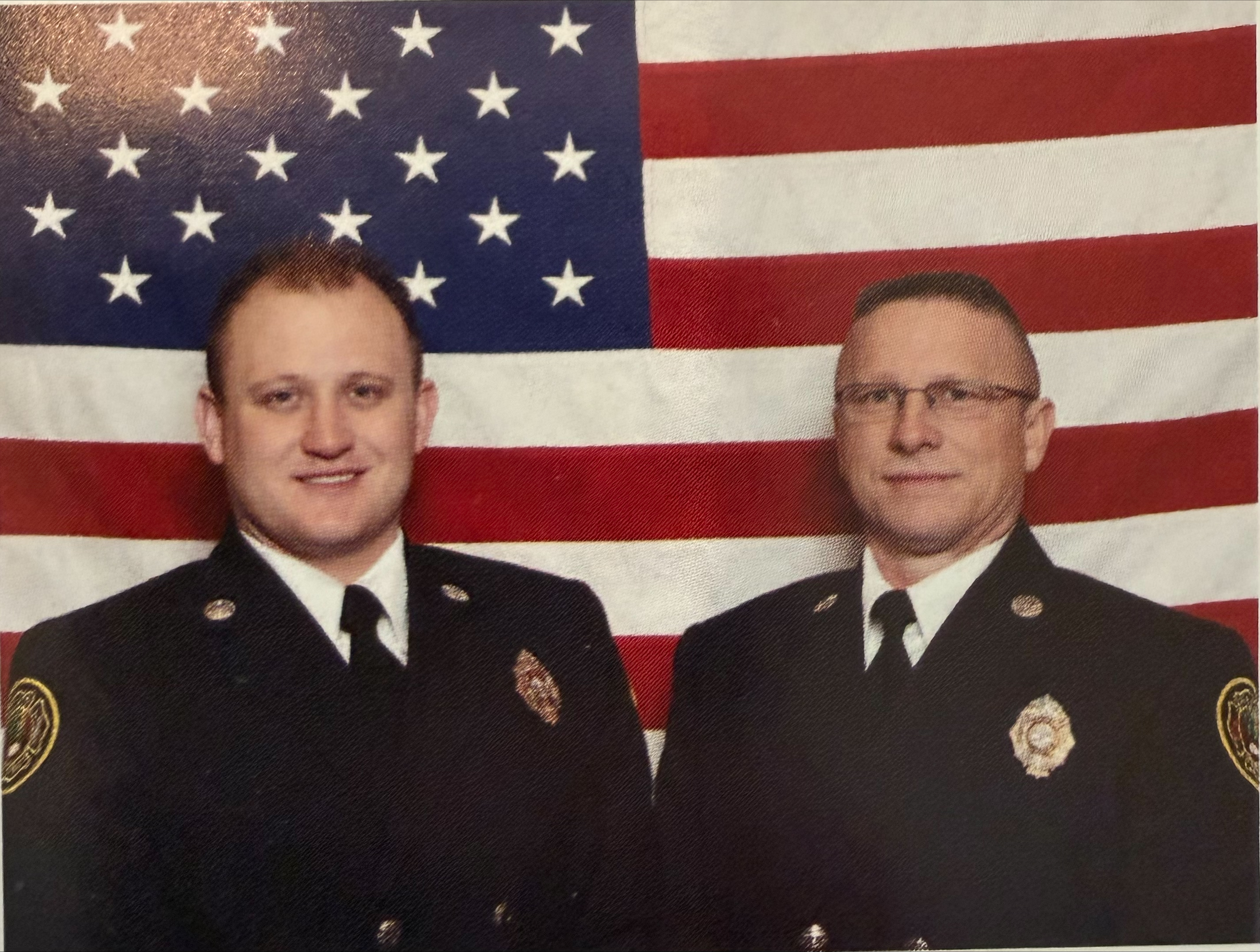 Charlotte Fire Engineer Cameron Ganous, left, poses with his father, retired firefighter Gregg Ganous, in an undated fire service photo.