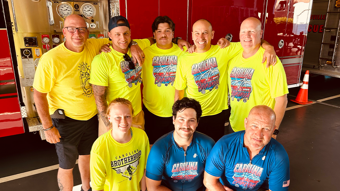 Members of Charlotte Fire participating in the 2025 Carolina Brotherhood Ride pause at a firehouse during their journey to honor fallen emergency responders and support their families.
