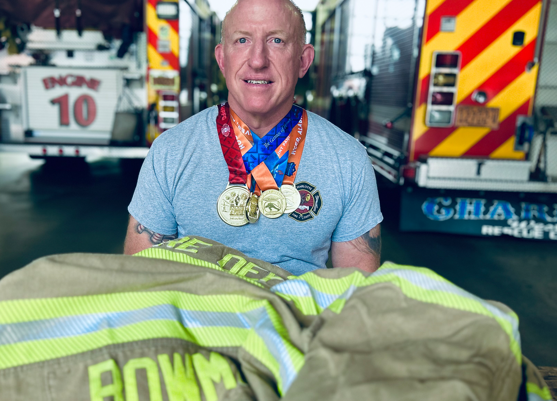 Surrounded by the tools of the job, Bowman wears several of the gold medals he earned on the world stage in the past year alone.