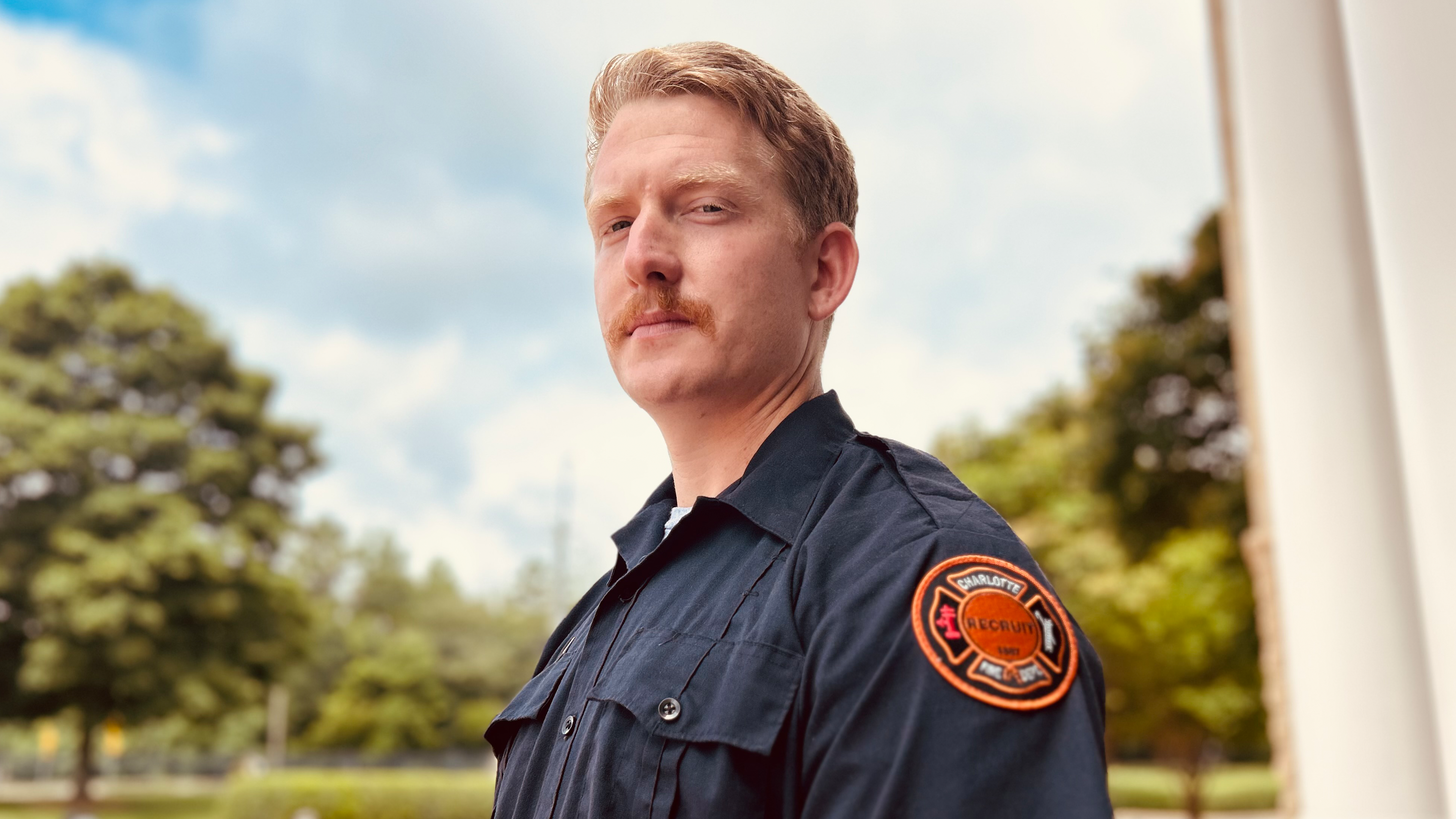 Edwards outside the Charlotte Fire Academy, where his EMT training helped prepare him for a real-world emergency just days after certification. 