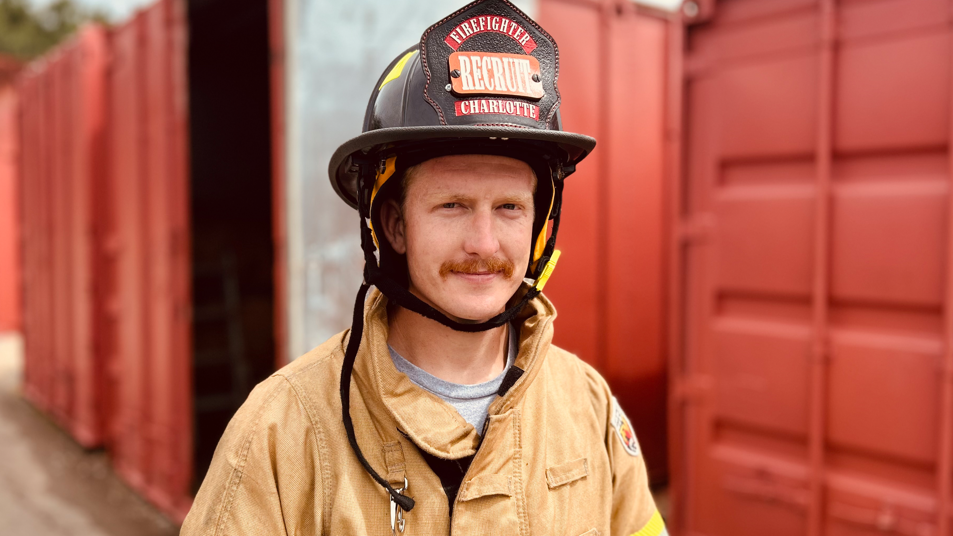 A look of determination as Charlotte Fire recruit David Edwards trains in live fire exercises. For him, the mission is personal—and already proven. 