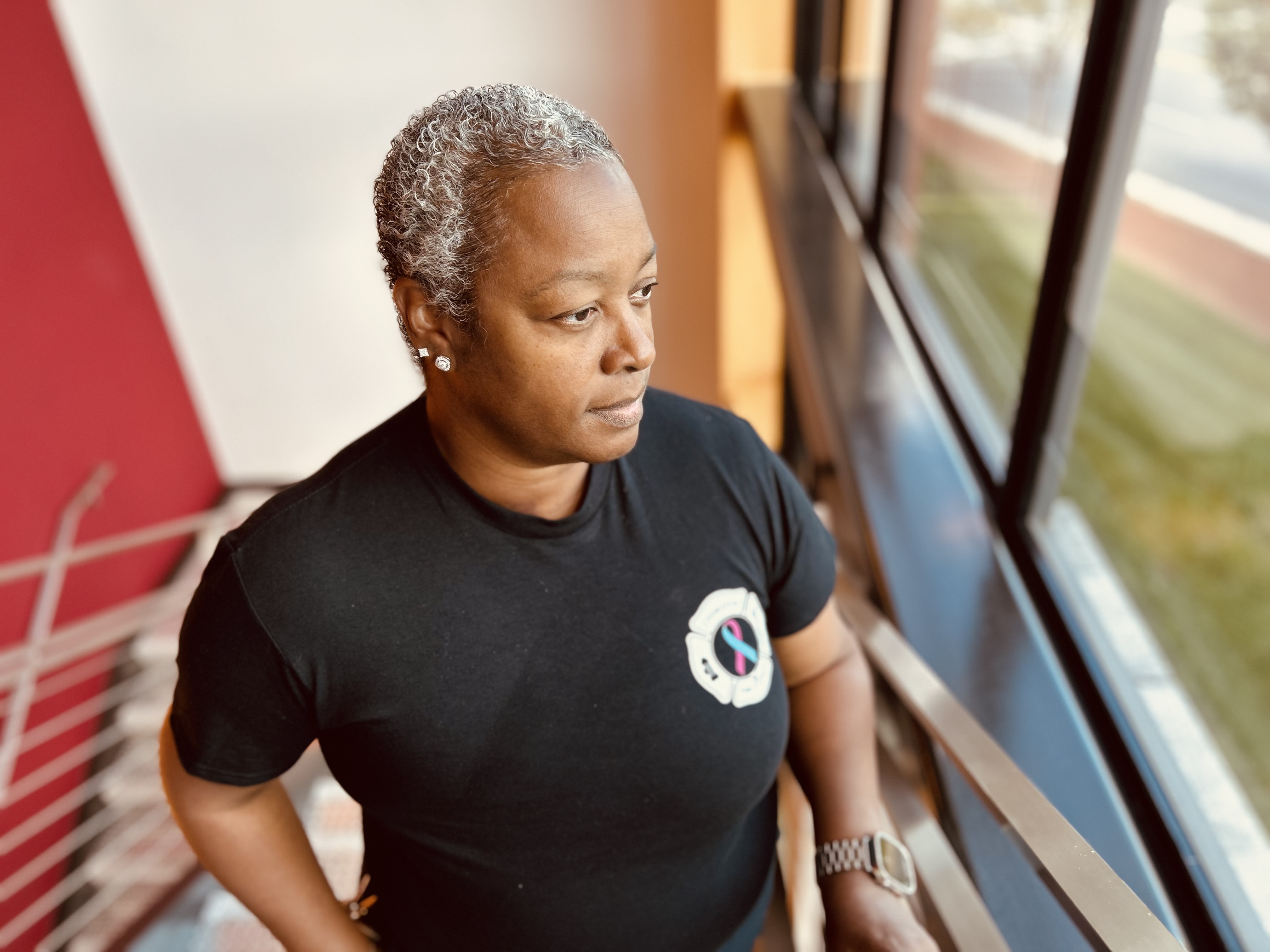 Looking out from the stairwell of Charlotte Fire Headquarters, Inspector Denise Reynolds reflects on the long months of treatment and the faith that sustained her.