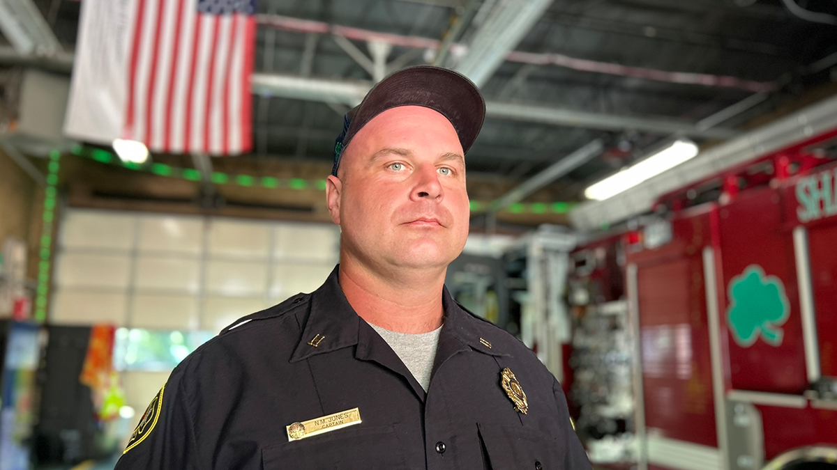 Captain Nathan Jones of Engine 15 stands by his apparatus, reflecting on the courage and teamwork that defined their response to one of the darkest days in Charlotte Fire history.