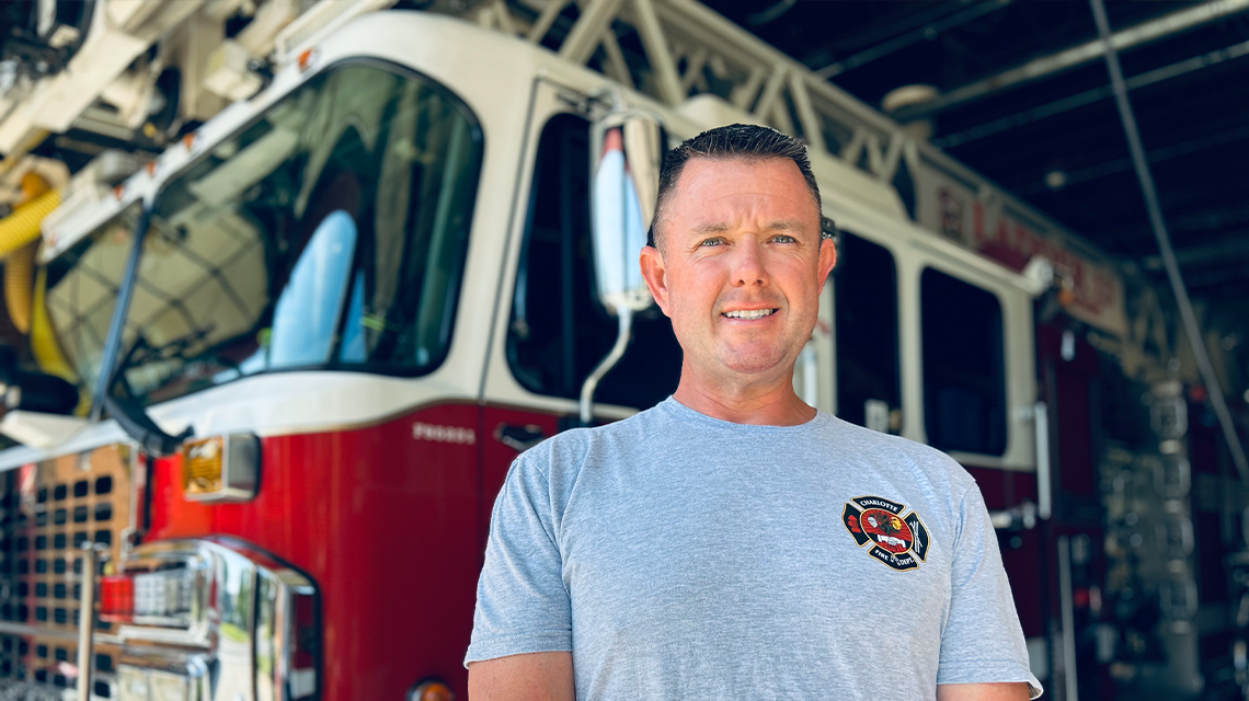 John Filliben in the bay of Firehouse 13, where he serves as a ladder driver for one of Charlotte Fire’s busiest companies and a mentor to aspiring firefighters.