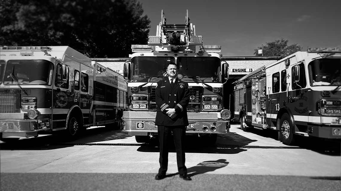 Engineer John Filliben stands outside Firehouse 13, where he serves as part of a high-performing crew responding to a wide range of emergencies across Charlotte