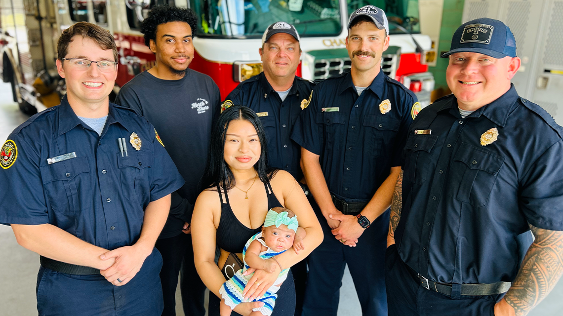 Halena Khen, Christian Chavis, and baby Leilani pose with the Engine 21 crew who helped during her surprise home birth. Pictured are Firefighters Grant White, Stephen Taylor, Engineer Josh Cook and Captain Shane Fields.