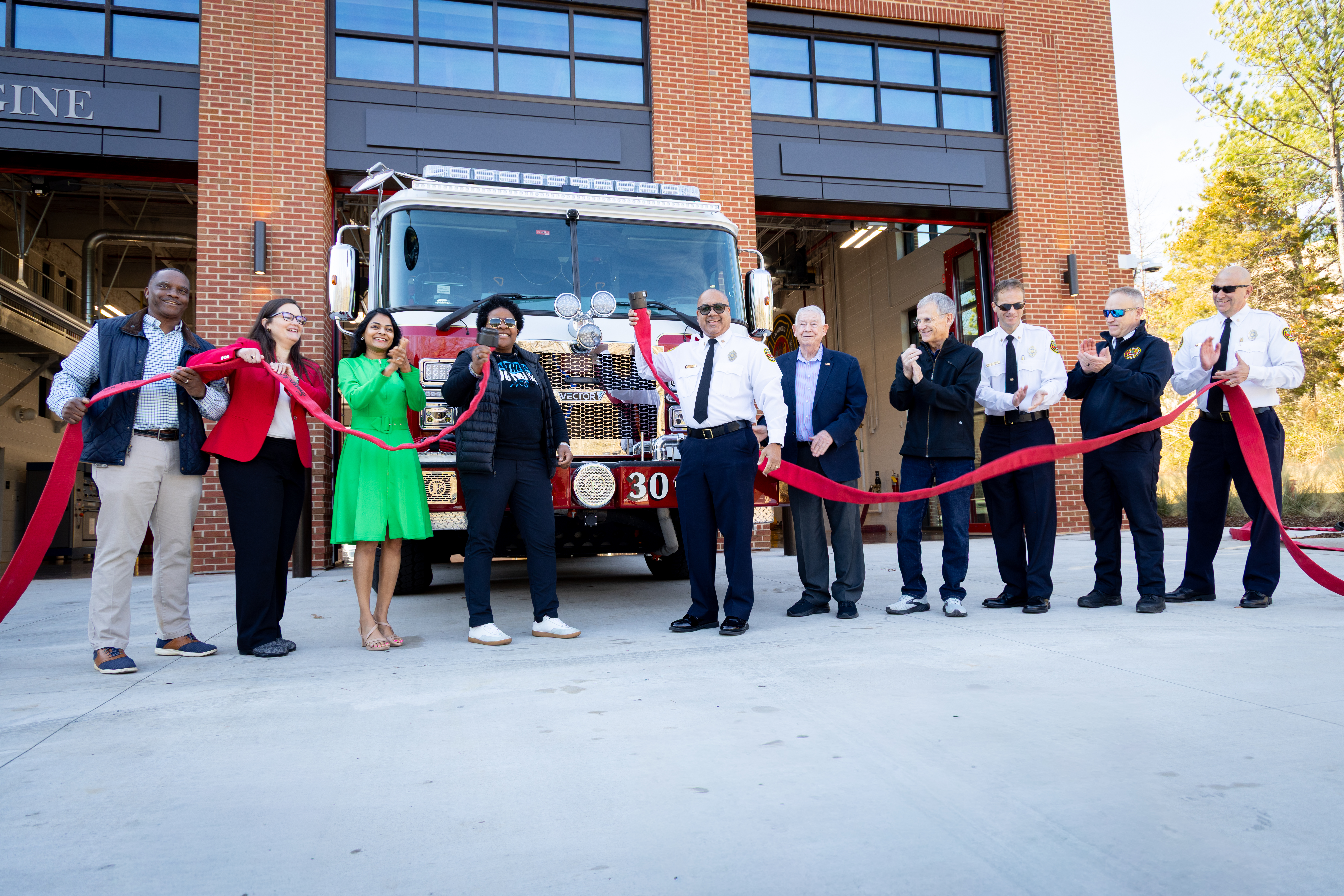 City leaders, Charlotte Fire Chief Reginald Johnson, and department representatives participate in the uncoupling ceremony outside Firehouse 30, officially placing the new firehouse into service. 
