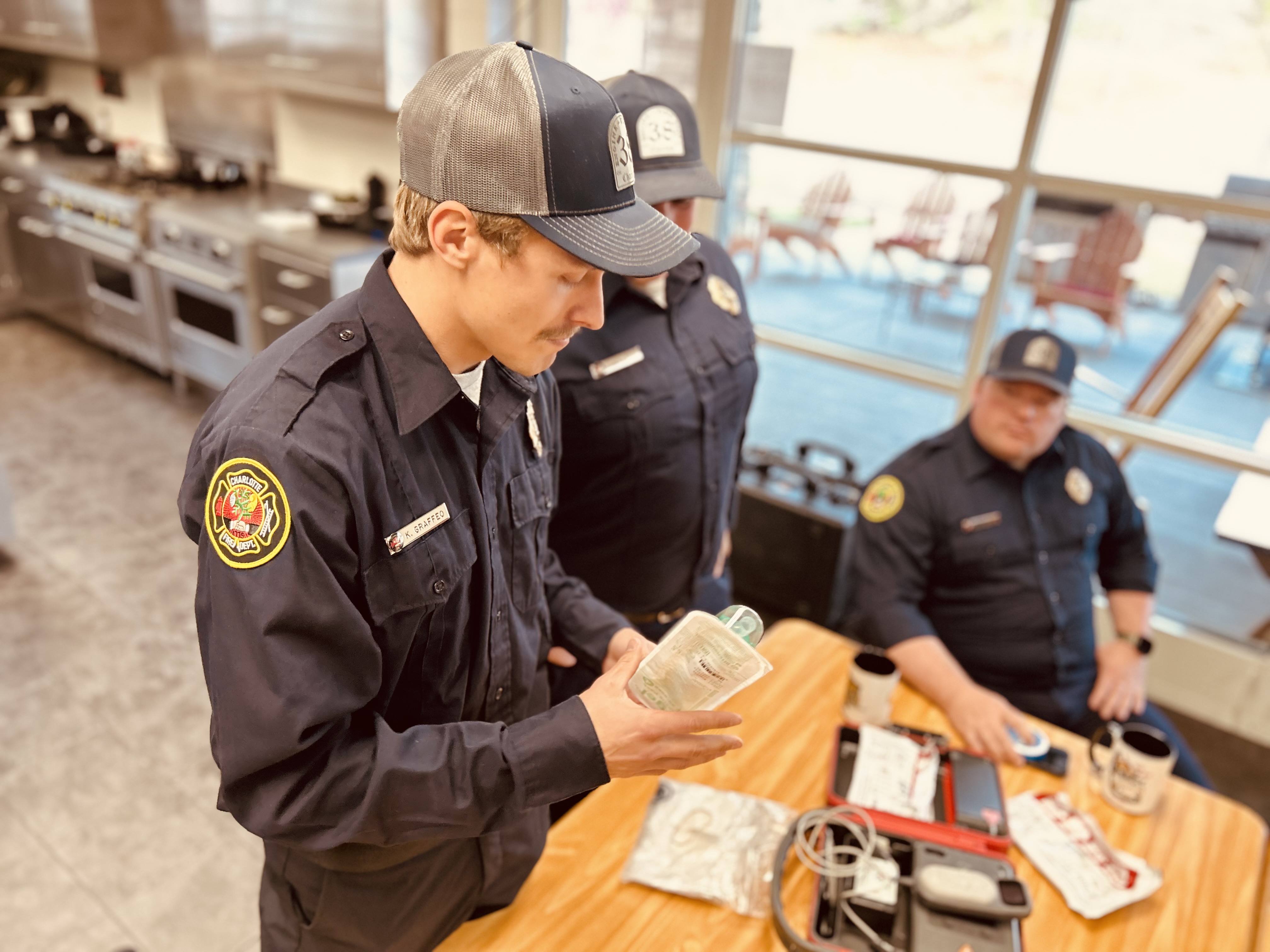 Firefighter Kyle Graffeo looks over the medical equipment he used that night, offering Darlene a hands-on explanation of how responders work under intense pressure. 