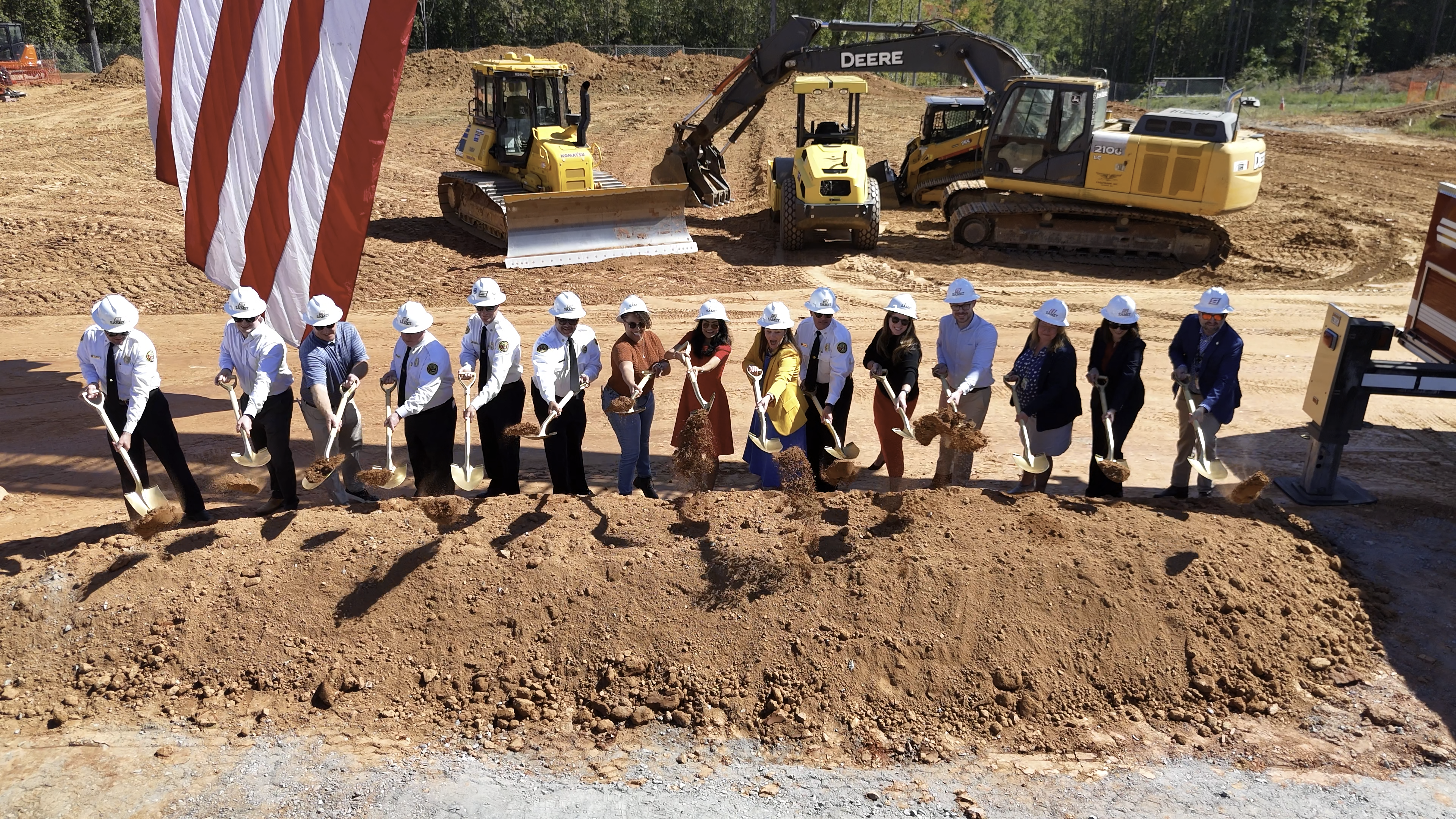 City leaders and project partners turn the first ceremonial shovels of dirt for Firehouse 44.