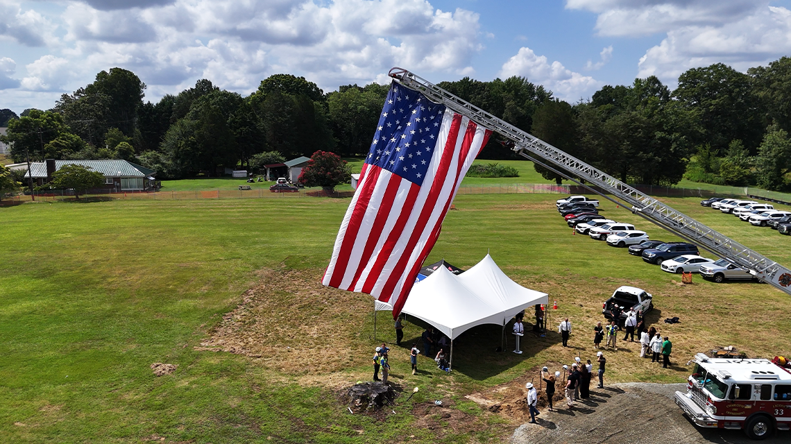 A wide aerial view shows the scope of the Firehouse 46 groundbreaking event, as community leaders, firefighters, and city officials gather to mark the start of construction.