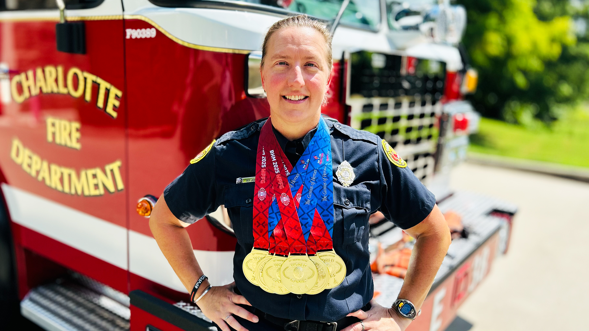 Charlotte Firefighter Holly Forbes Johnson wears her six gold medals, marking a career-defining moment both in and out of the water. 