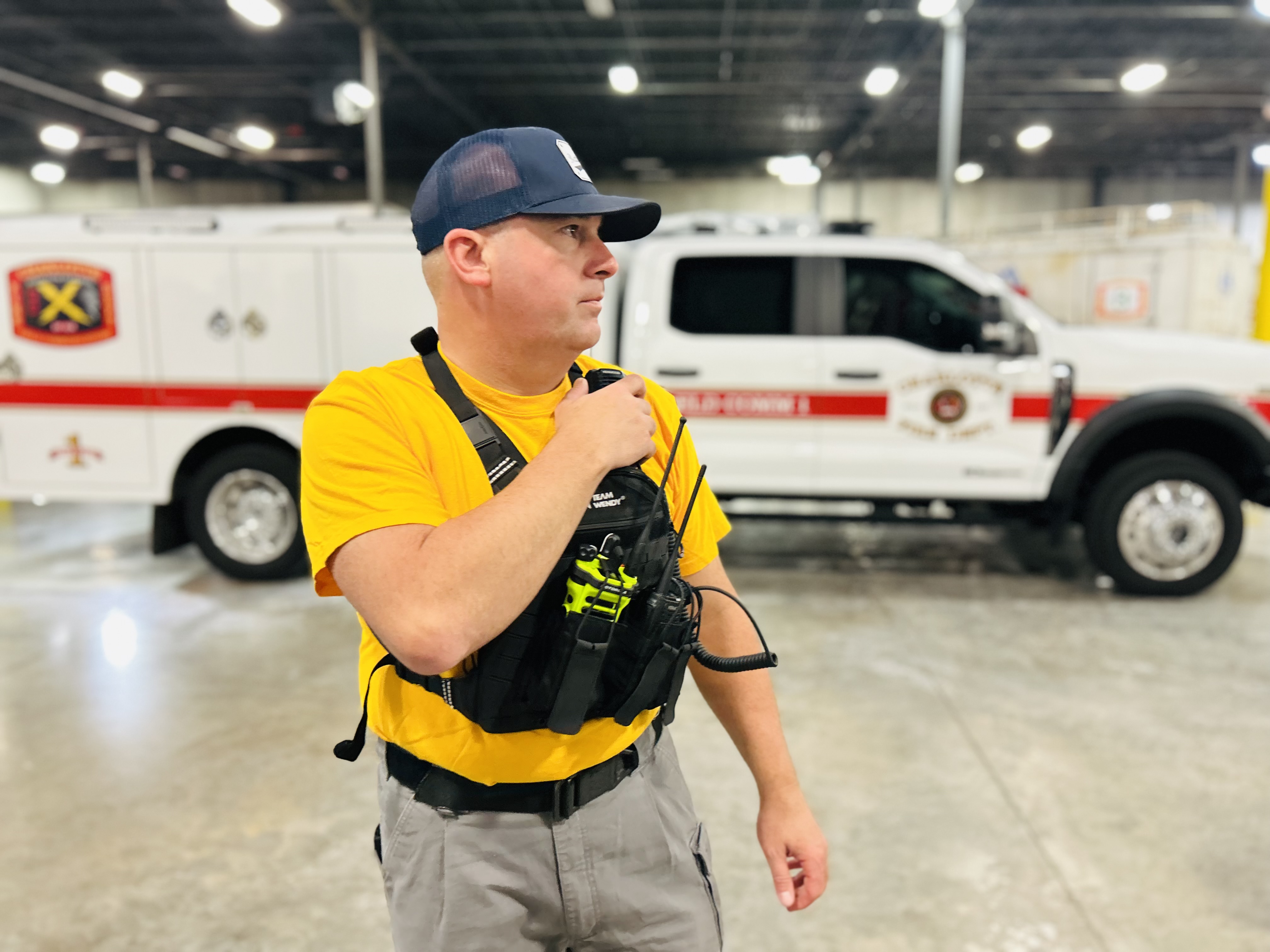 Battalion Chief Monteith coordinates final communications as Charlotte Fire Task Force 3 prepares to depart for Edenton. 
