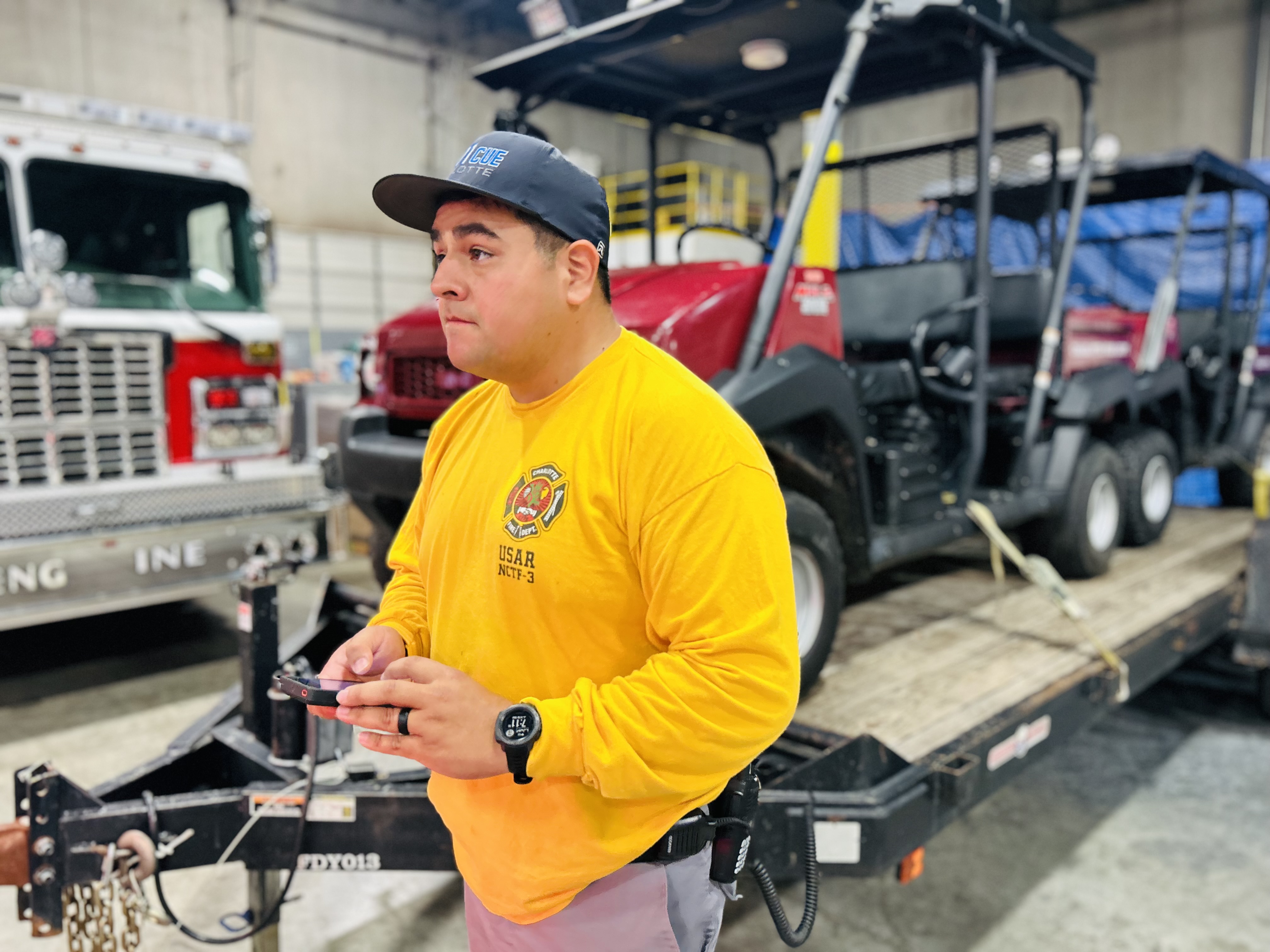 Firefighter Muniz checks final gear lists as crews load equipment for potential swift water rescue operations following Hurricane Erin.