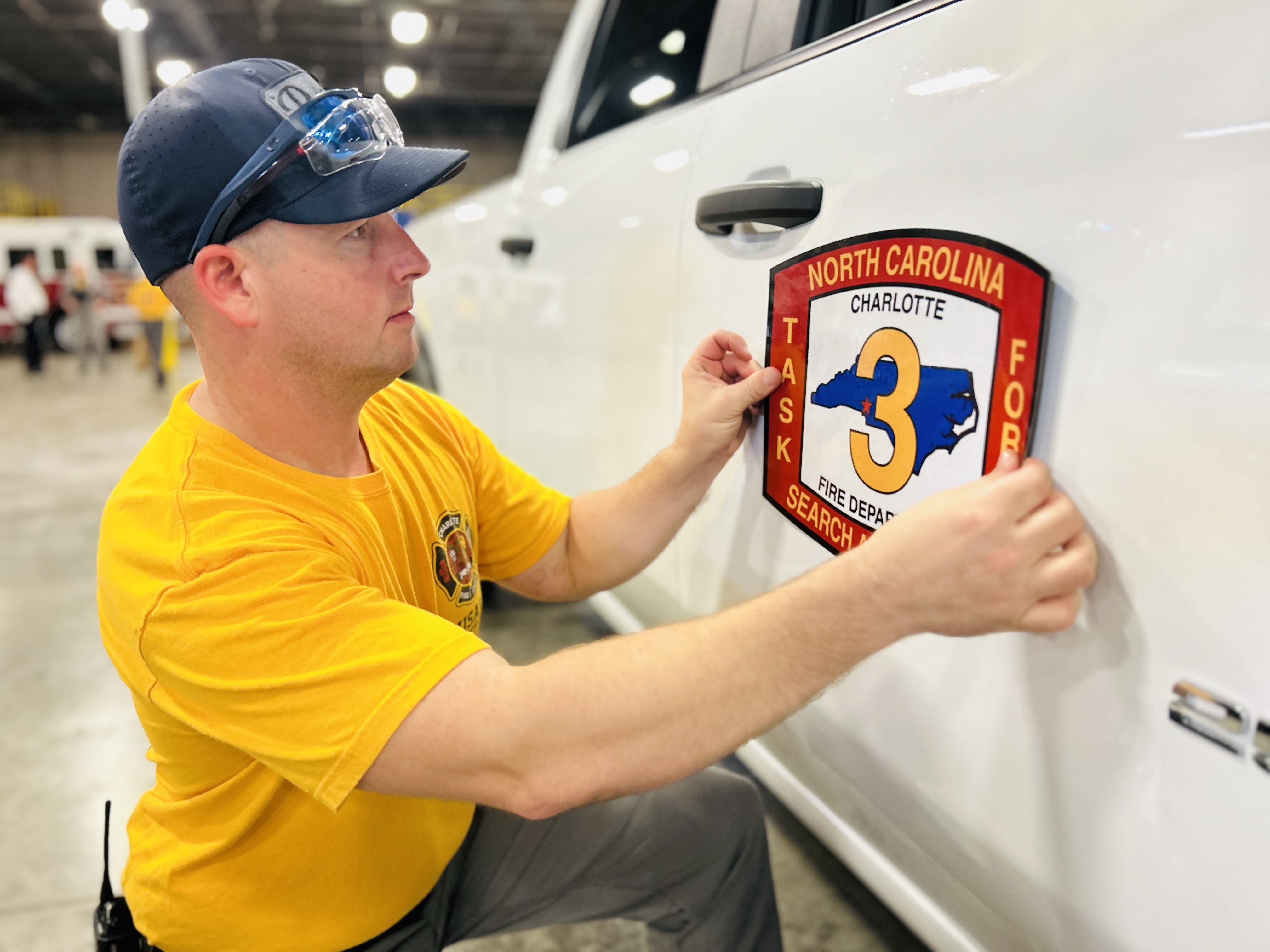 Capt. Hodnett places the North Carolina Task Force 3 insignia on a response vehicle before deployment to Edenton. 