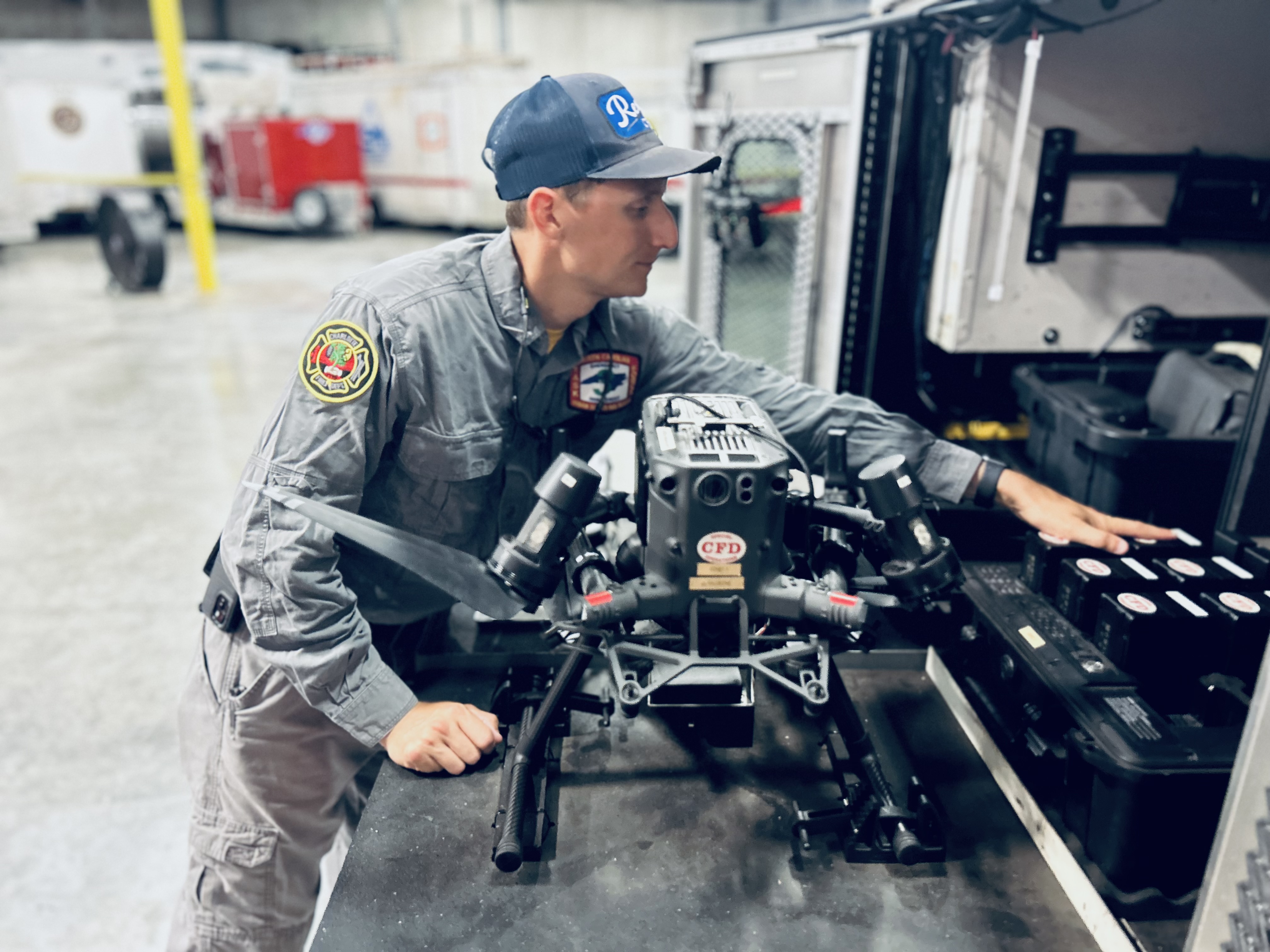 Firefighter Watts prepares Charlotte Fire’s drone equipment before departure, ensuring the team is ready for aerial support in flood-affected areas. 