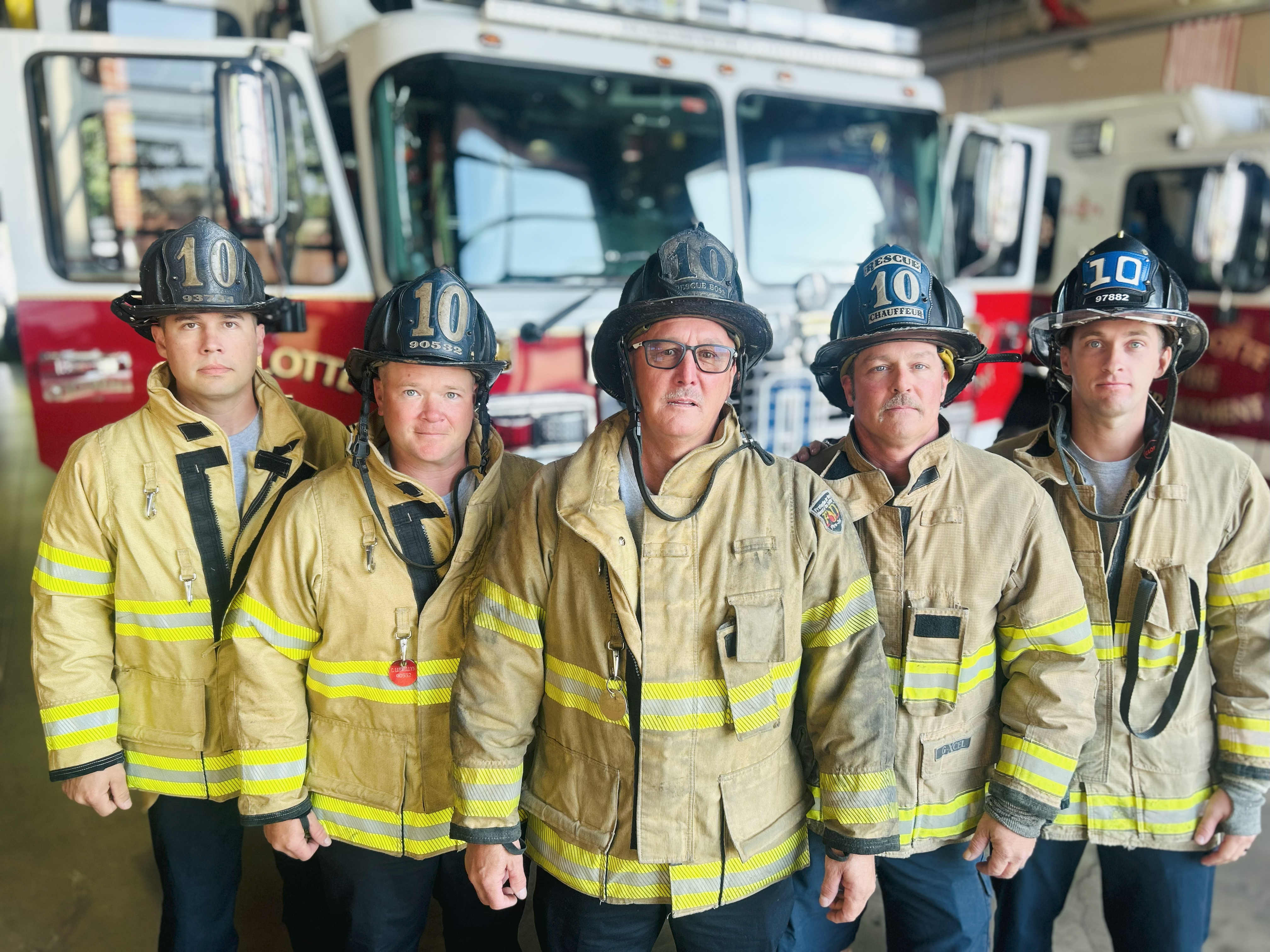 Capt. Jerry Rodgers stands with the Rescue 10 crew at Firehouse 10, a company he has led through some of Charlotte Fire’s most challenging calls.