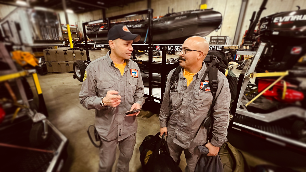 Task Force Three members double-check equipment, ensuring all necessary tools for swift water rescues and emergency operations are packed before heading into the disaster area. 