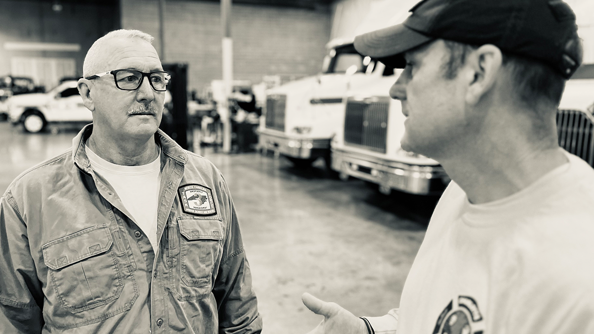 Captain Jerry Rogers speaks with Battalion Chief Josh Johnson as they finalize preparations for the deployment to Kentucky, ensuring all logistics and personnel are ready for the mission.