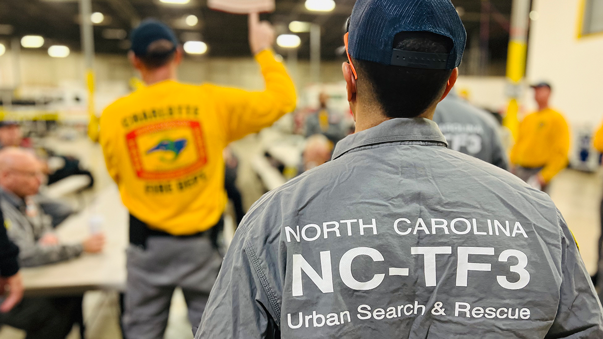 Members of North Carolina Task Force Three receive a final briefing before deploying to Kentucky, where they will provide critical water rescue and emergency response support.