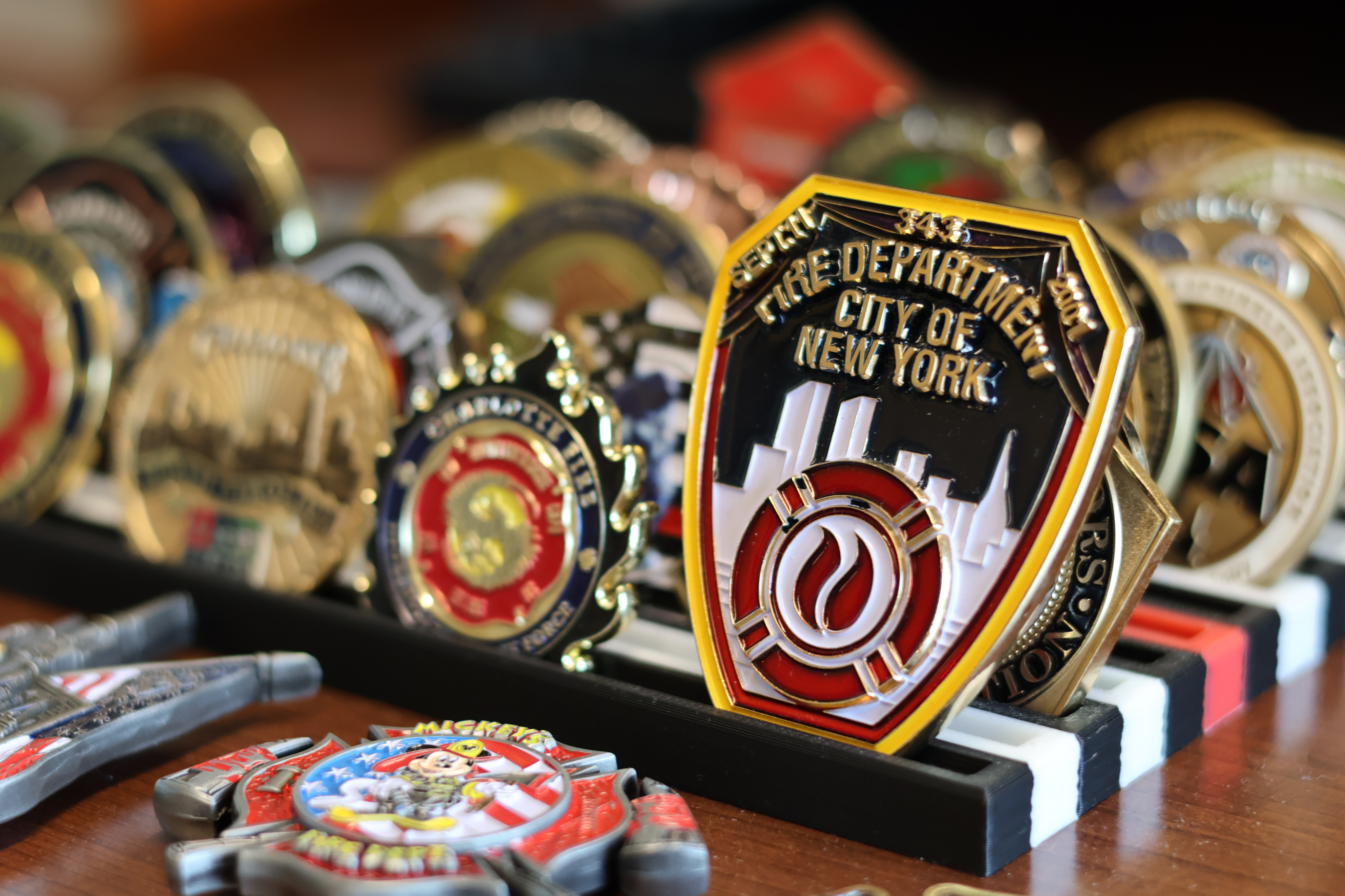 An FDNY challenge coin displayed among Miller’s keepsakes represents a connection to the department and firefighters who helped shape his life.