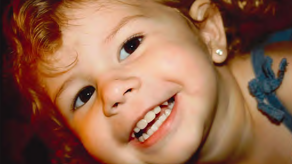 A close-up of Kilah’s bright, infectious smile—a moment frozen in time, capturing the joy and light she brought into the world.